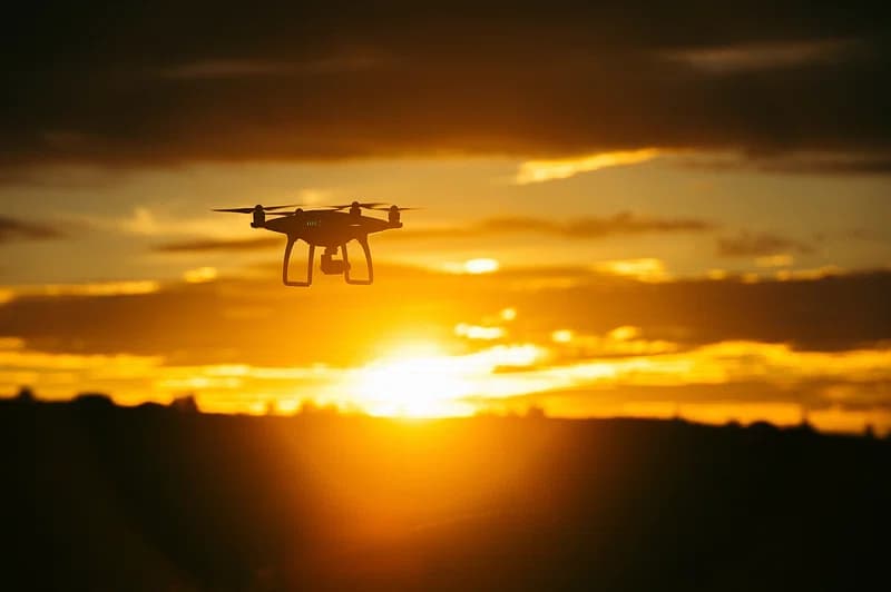 Drone flying over the sunset sky.